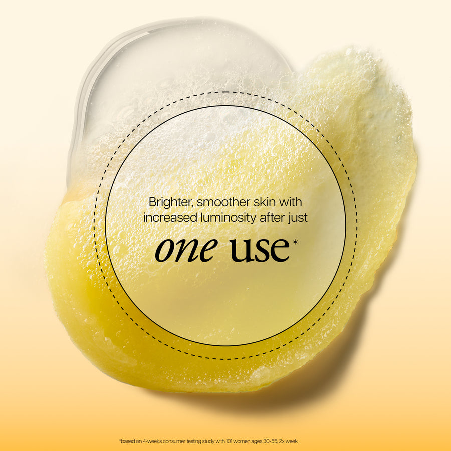 A yellow, translucent, gel-like beauty sponge or pad shown on a soft beige-to-yellow gradient background. A large oval overlay reads, 'Brighter, smoother skin with increased luminosity after just one use' with 'one use' in large black text.