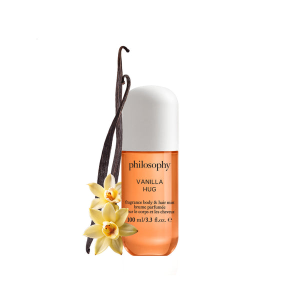 Philosophy Vanilla Hug perfume bottle with vanilla bean and flowers on a white background