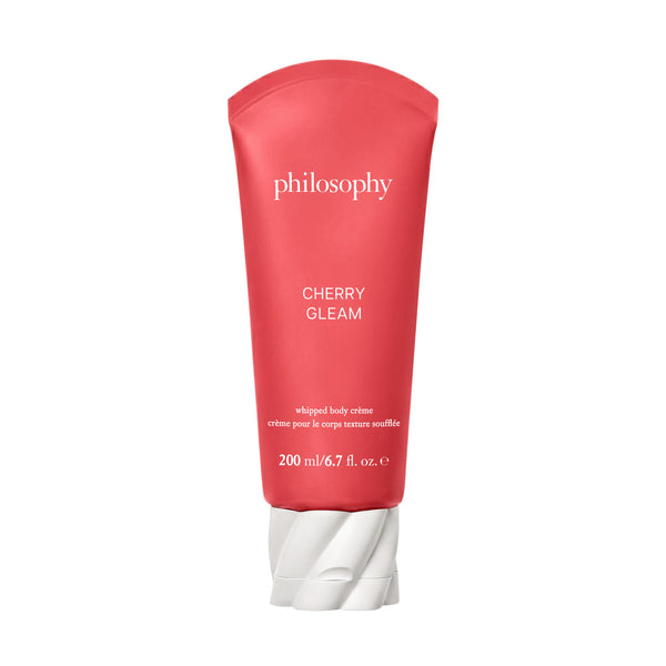 A red squeeze tube of Philosophy Cherry Glem whipped body cream with a white cap, centered on a plain white background.