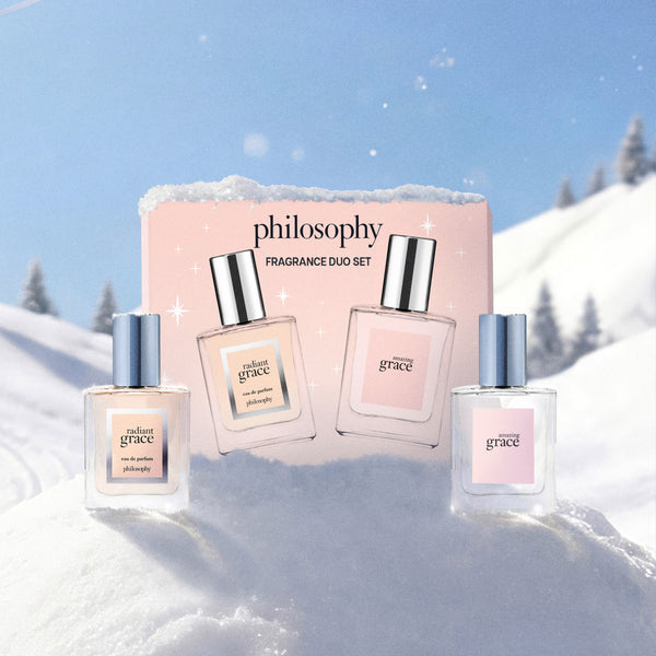 Philosophy Fragrance Duo Set with three perfume bottles and a pink box, styled against a snowy mountain background under a blue sky.