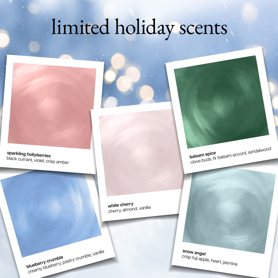 A promotional graphic for a limited holiday scents collection, showing five Polaroid-style scent cards with swatches and labels: sparkling holybories, balsam spice, white cherry, blueberry crumble, and snow angel, on a soft blue bokeh background with the headline 'limited holiday scents'.