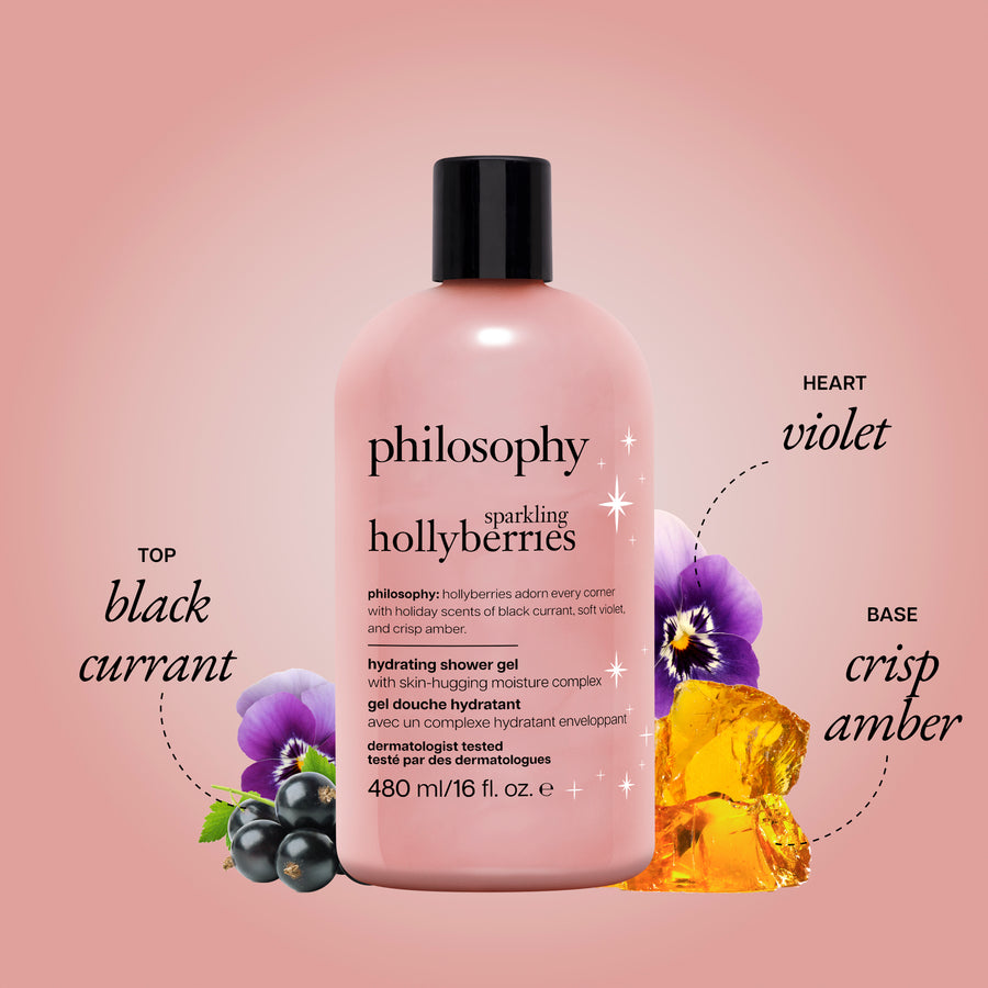 A bottle of Philosophy Hollyberries hydrating shower gel centered on a soft pink background, with decorative text and fruit/flower graphics indicating scent notes: top black currant, heart violet, and base crisp amber.